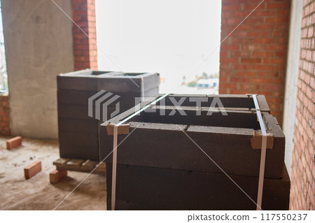 An Array of Stacked Concrete Blocks Positioned in a Brick Walled Storage Space Area An Array of Stacked Concrete Blocks Positioned in a Brick Walled Storage Space Area 117550237