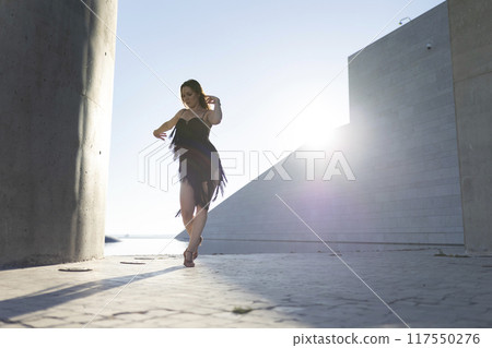 Professional dancer performing modern ballet choreography outdoors Professional dancer performing modern ballet choreography outdoors 117550276