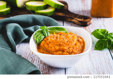Delicious squash caviar and basil in a bowl on the table Delicious squash caviar and basil in a bowl on the table 117551041