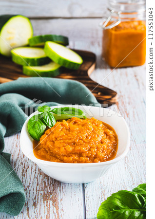 Delicious squash caviar and basil in a bowl on the table vertical view Delicious squash caviar and basil in a bowl on the table vertical view 117551043