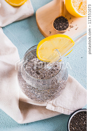 Super food cocktail chia water with lemon in a glass on the table vertical view Super food cocktail chia water with lemon in a glass on the table vertical view 117551073