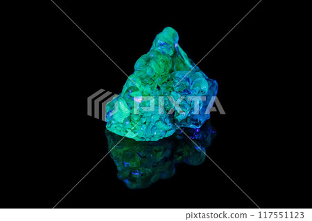 macro mineral stone opal under ultraviolet light on a black background 117551123