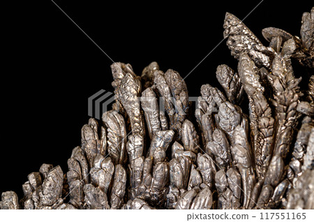 Macro of a stone Stibnite mineral on a black background 117551165