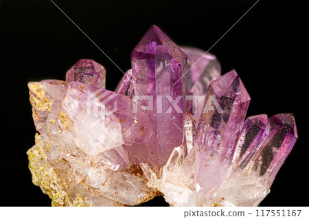 Macro of amethyst mineral stone on black background 117551167