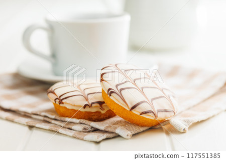 Sweet dessert with sugar coating on white table. 117551385