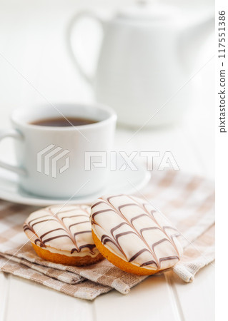 Sweet dessert with sugar coating on white table. 117551386