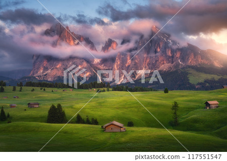 Colorful landscape with alpine mountains in low clouds and houses Colorful landscape with alpine mountains in low clouds and houses 117551547