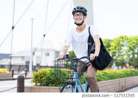A man riding a bicycle A man riding a bicycle 117551595