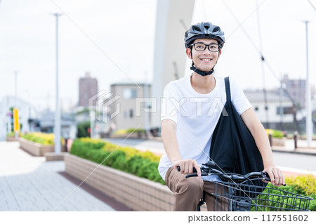 A man riding a bicycle A man riding a bicycle 117551602