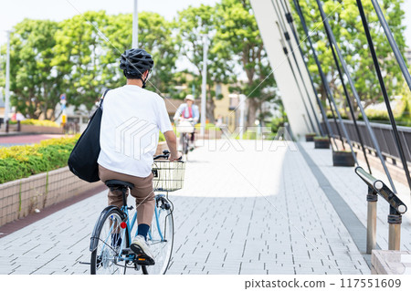 A man riding a bicycle A man riding a bicycle 117551609