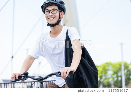 A man riding a bicycle 117551617