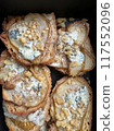 A closeup of a stack of French toast with cheese and walnuts 117552096