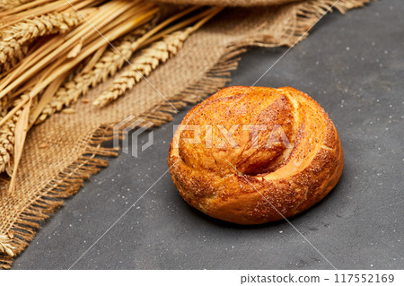Freshly baked cinnamon roll with a golden crust and a sprinkle of sugar, perfect for a sweet treat Freshly baked cinnamon roll with a golden crust and a sprinkle of sugar, perfect for a sweet treat 117552169