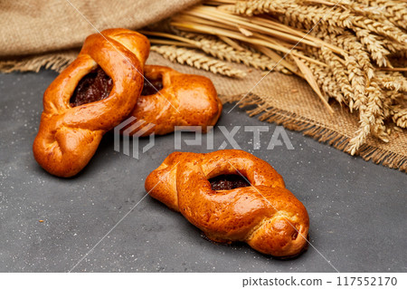 Golden-brown pastries filled with fruit jam, perfect for a delicious breakfast or sweet snack 117552170