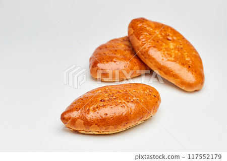 Golden-brown homemade pastries with a glossy crust, perfect for breakfast or a sweet snack Golden-brown homemade pastries with a glossy crust, perfect for breakfast or a sweet snack 117552179