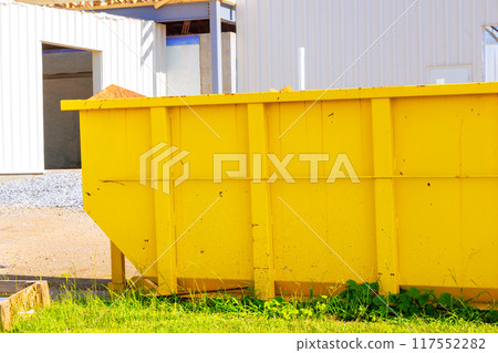 Construction site with metal container dumpsters for storing waste during construction 117552282