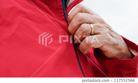 Hand Of A Man Unzipping The Raincoat Hand Of A Man Unzipping The Raincoat 117552566