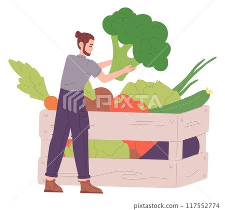 Young man choose vegetables from wooden box. Local farm food Young man choose vegetables from wooden box. Local farm food 117552774