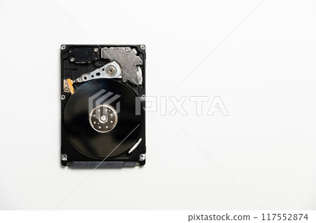 White background on which lies a sleek hard drive, combining modernity and simplicity in a technologically minimalist aesthetic. White background on which lies a sleek hard drive, combining modernity and simplicity in a technologically minimalist aesthetic. 117552874