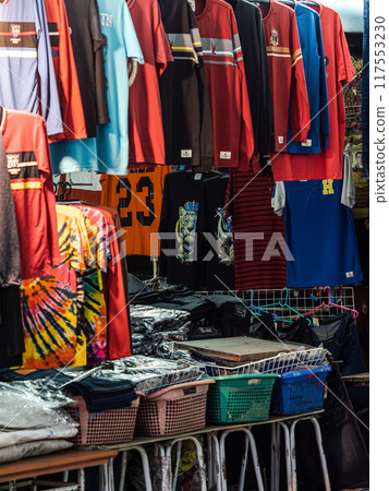 Colorful T-Shirts Hanging at a Market Stall Colorful T-Shirts Hanging at a Market Stall 117553230