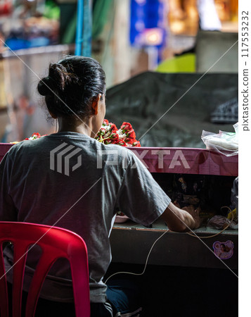 Woman Working at a Stall in a Market Woman Working at a Stall in a Market 117553232