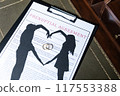 A prenuptial agreement with a silhouette of a couple and wedding rings, symbolizing marital contracts and legal preparation. 117553388