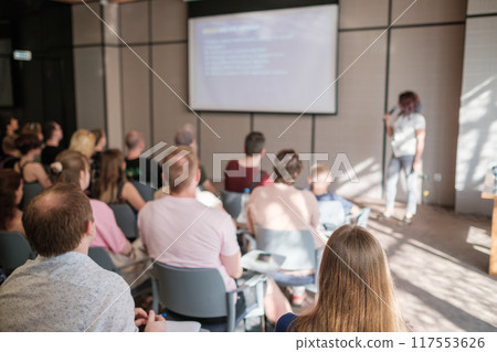 Audience attentively listening to speaker at business seminar Audience attentively listening to speaker at business seminar 117553626