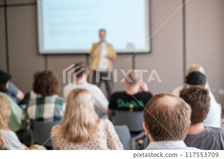Speaker giving a presentation to attentive audience in conference room 117553709