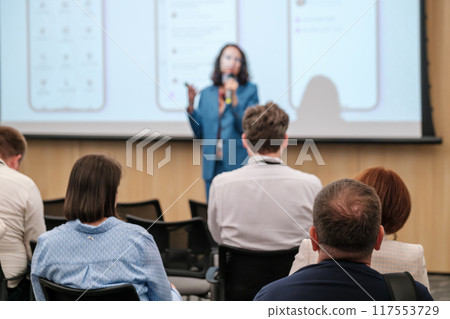 Professional business presentation with audience listening attentively 117553729