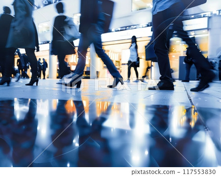 Blurred motion of people walking in busy city shopping mall Blurred motion of people walking in busy city shopping mall 117553830