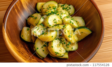 A bowl of sliced cucumbers with a sprinkle on top, AI 117554126