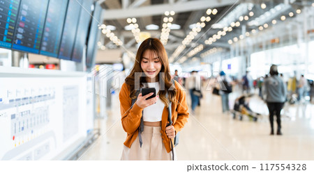 Young asian woman in international airport Young asian woman in international airport 117554328