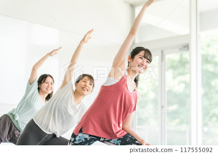 Women doing stretching and flexibility exercises at the gym 117555092