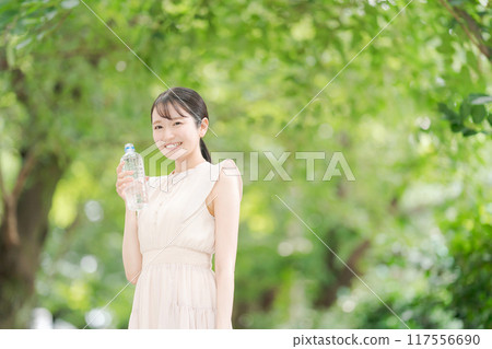 A woman with a bottle of water A woman with a bottle of water 117556690
