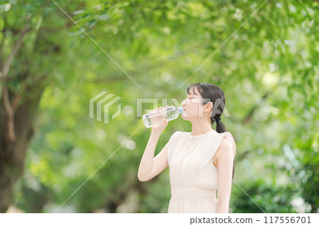 A woman with a bottle of water A woman with a bottle of water 117556701