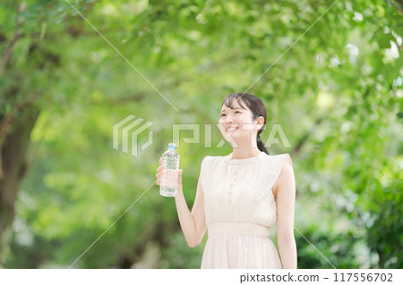 A woman with a bottle of water A woman with a bottle of water 117556702