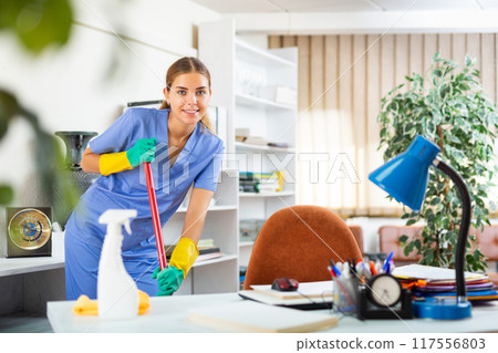 Woman cleaning floor with mop 117556803