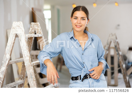 Portrat of cheerful young woman inside construction site Portrat of cheerful young woman inside construction site 117556826