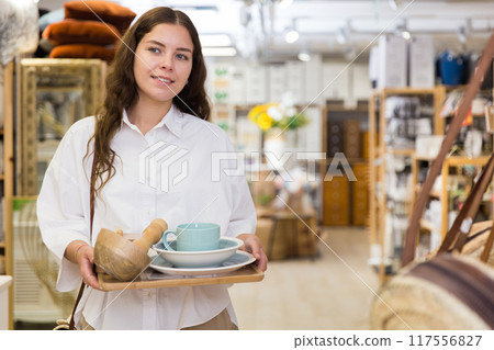 Woman shopping at store of household goods Woman shopping at store of household goods 117556827
