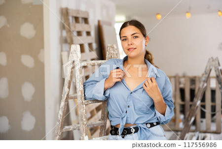 Portrait of young woman standing in apartment 117556986