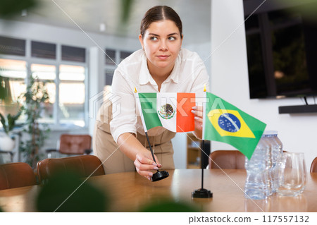female assistant prepares conference room for diplomats of Brazil and Mexico 117557132