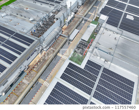 Solar energy for factory and warehouse building. Solar panels on roof of industrial plant. Commercial solar power. Rooftop solar power. Rooftop renewable energy system. Sustainable green energy. 117557460