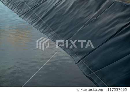 Aquaculture farming pond liner system. HDPE geomembrane technology. Water containment and environmental protection in sustainable fish farming. High-density polyethylene transforms aquaculture ponds. 117557465