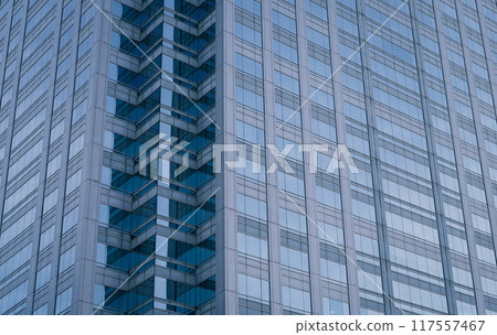 Skyscraper glass building of corporate headquarters in the downtown business area. Towering facade and windows embodying sleek, modern office environment. Financial institution. Modern architecture. 117557467