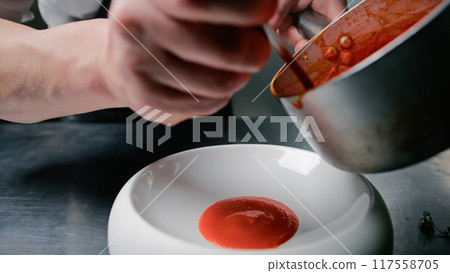 Chef Pouring Tomato Sauce For Plating  117558705