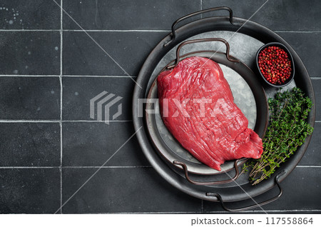 Fresh Raw flank beef meat steak and ingredients for cooking. Black background. Top view. Copy space Fresh Raw flank beef meat steak and ingredients for cooking. Black background. Top view. Copy space 117558864