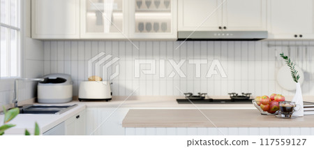 A wood kitchen island countertop in a modern minimalist white kitchen. 117559127