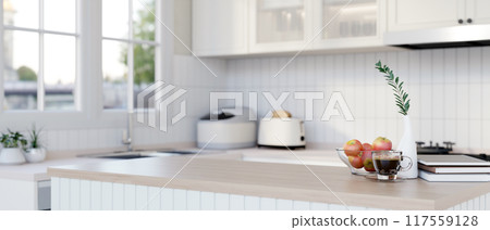 A wood kitchen island countertop in a modern minimalist white kitchen. 117559128