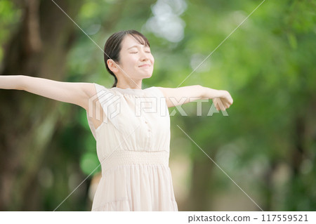 A woman bathing in the forest in the park A woman bathing in the forest in the park 117559521