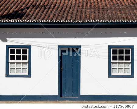 Traditional White House with Blue Wooden Door and Windows Traditional White House with Blue Wooden Door and Windows 117560907